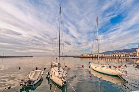 Pleasure boats moored in harbor in sunny day. Trieste Italy