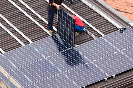 Installation of solar panels on a roof.の写真素材