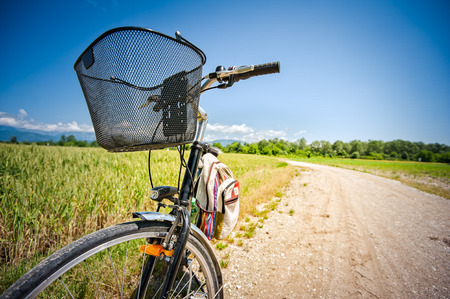 Close Up on bicycle on rural road. Image concept for healthy lifestyle, bike travel.の写真素材