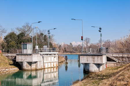 Canal lock and traffic light for regulation of boat traffic.の写真素材