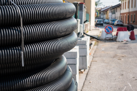 Roll of plastic pipe for road works. Protection of electric or telephone cables.の写真素材