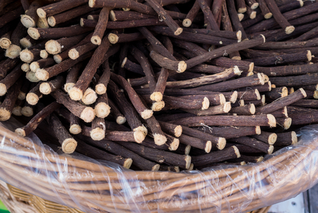 Liquorice roots on  wicker basket, exposed for sale at a fair.の写真素材