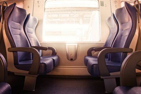 Interior of a passenger train with empty seatsの写真素材