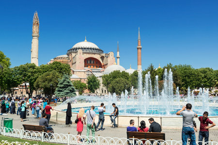 Tourists walk next to Hagia Sophia on may 26, 2013 in Istanbul, Turkey  Hagia Sophia is the greatest monument of Byzantine Culture and tourist attraction のeditorial素材