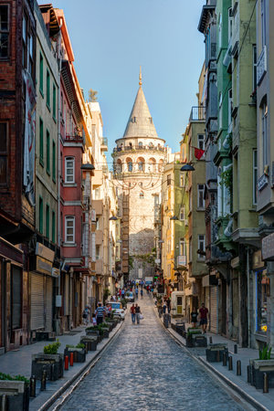 View of old narrow street with the Galata Tower on may 26, 2013 in Istanbul, Turkey  The Galata Tower is the greatest monument of Middle Ages のeditorial素材