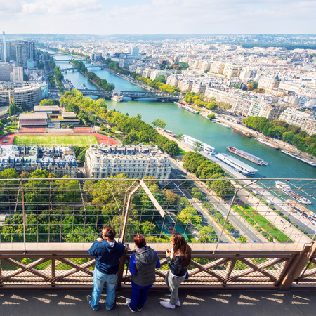 Tourists are on the observation deck of the Eiffel Tower in Paris  The Eiffel tower is one of the major tourist attractions of France の写真素材