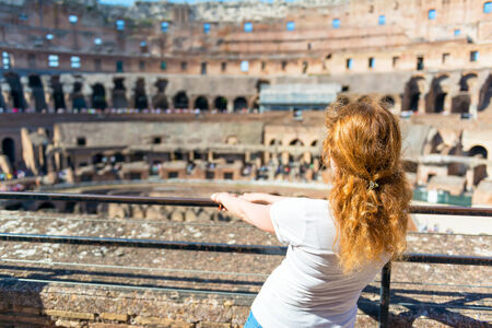 Young female redhead tourist inside the Colosseum in Rome, Italyの写真素材