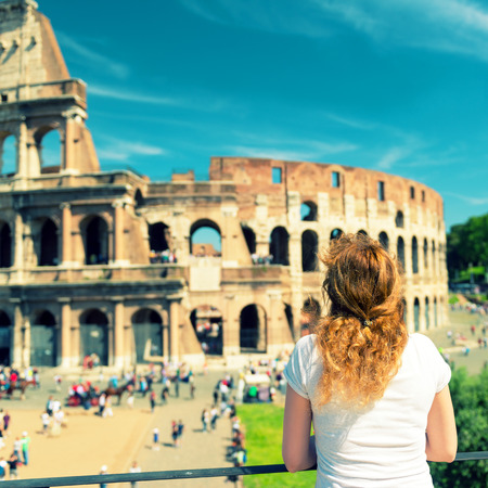 Young female tourist looks at the Colosseum in Rome, Italy  Vintage photo の写真素材
