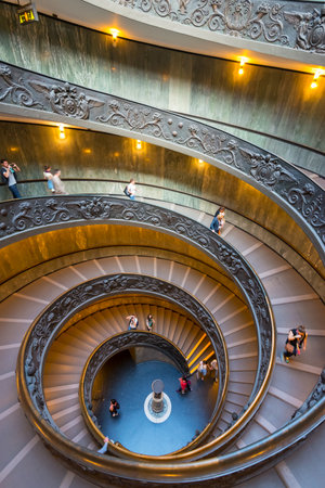 Tourists walk down the famous spiral staircase with beautiful rails in Vatican Museum.のeditorial素材