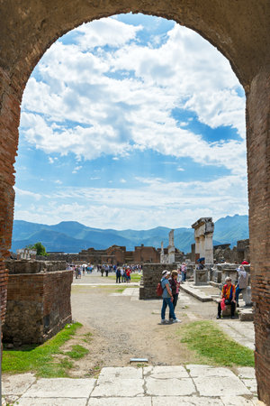 POMPEII, ITALY - MAY 13, 2014: Tourists visit the ruins of the city. Pompeii is an ancient Roman city died from the eruption of Mount Vesuvius in 79 AD.のeditorial素材