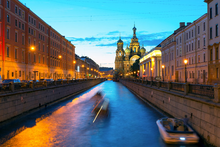 Tourist boats sail to the Church of Savior on Spilled Blood at White Night in Saint Petersburg, Russia. This is an architectural landmark of central St Petersburg, and a unique monument to Alexander II.の写真素材