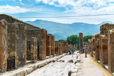 POMPEII, ITALY - MAY 13, 2014: Tourists visit the ruins. Pompeii is an ancient Roman city died from the eruption of Mount Vesuvius in 79 AD.のeditorial素材