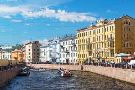 ST PETERSBURG, RUSSIA - JUNE 14, 2014: The Moyka River with tourist boats. St. Petersburg was the capital of Russia and attracts many tourists.のeditorial素材