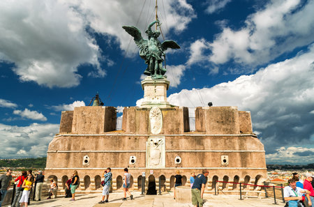 ROME - OCTOBER 2, 2012: Tourists visit the observation deck of the Castel Sant'Angelo. Saint Michael statue at top.のeditorial素材