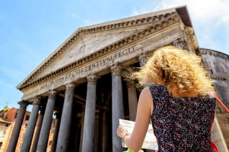 The girl looks at a tourist map in front of the Pantheon in Rome, Italyの写真素材