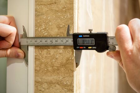 Workers use a electric calipers during the construction of the home's interior