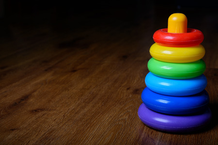 Toy pyramid on the dark floor background, concept