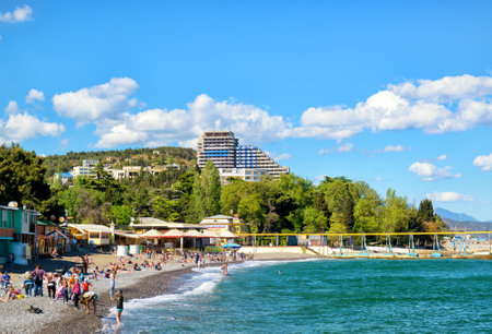 ALUSHTA, RUSSIA - MAY 15, 2016: Tourists sunbathe and swim at the beach. Alushta is a well-known resort in the Crimea.のeditorial素材