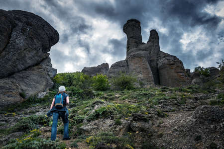Female tourist walks in the Valley of Ghosts on the Demerdji mountain. Landscape of Crimea, Russia.の写真素材