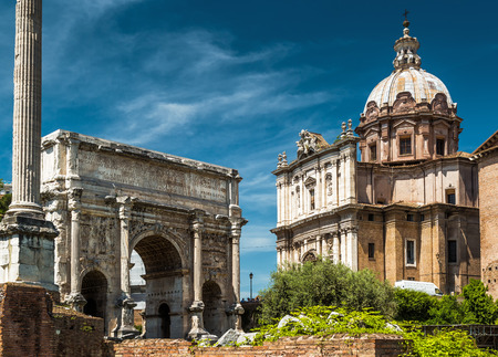 Triumphal arch of the emperor Septimius Severus and medieval church of Santi Luca e Martina in the Roman Forum, Rome, Italyの写真素材