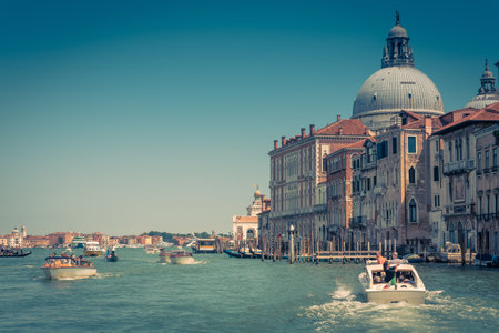 Water taxis and other boats are sailing along the Grand Canal in Venice, Italy. Motor boats are the main transport in Venice.のeditorial素材