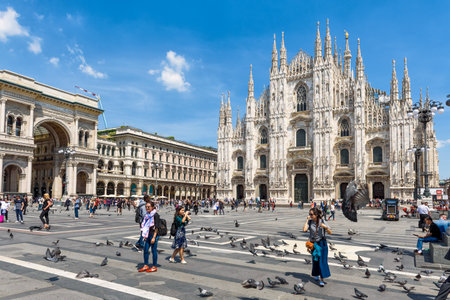 MILAN, ITALY - MAY 16, 2017: Tourists take pictures in front of the Milan Cathedral (Duomo di Milano) on a summer day. Milan Duomo is the largest church in Italy.のeditorial素材