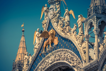 Facade of the Basilica di San Marco (Saint Mark's Basilica) in Venice, Italy. The winged lion is a symbol of Venice.の写真素材