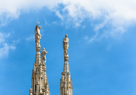 Marble statues on the stone spiers of the roof of the Milan Cathedral in Milan, italy. Milan Duomo is the largest church in Italy and the fifth largest in the world.の写真素材