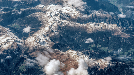 Aerial view of the Alpine mountains from an airplaneの写真素材
