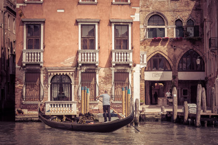 Venice, Italy - May 18, 2017: The gondola with tourists floats along the canal. Gondola is the most attractive tourist transport in Venice.のeditorial素材