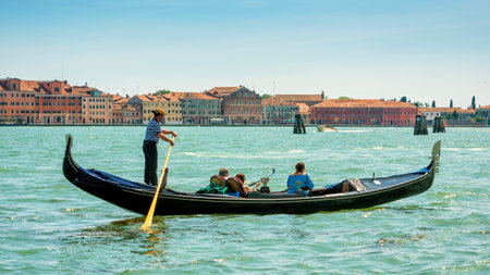 Venice, Italy - May 18, 2017: Gondola with tourists floats along the Grand Canal. Gondola is the most attractive tourist transport in Venice. 16:9 widescreen.のeditorial素材
