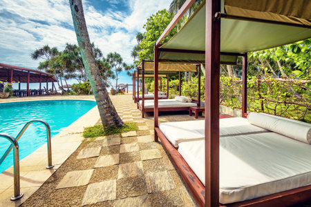 Sri Lanka - November 4, 2017: Swimming pool and beach beds in a tropical hotelのeditorial素材