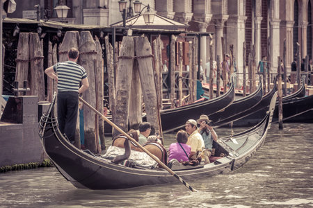 Venice, Italy - May 18, 2017: The gondola with tourists floats along the Grand Canal. Gondola is the most attractive tourist transport in Venice.のeditorial素材