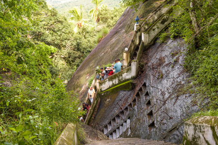 Mulkirigala, Sri Lanka - November 4, 2017: Tourists descend the stairs from the ancient Buddhist...