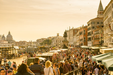 Venice - May 18, 2017: Crowds of people are at the San Marco Embankment in Venice, Italy. It is one of the main tourist attractions of Venice. Sunny panorama of Venice.のeditorial素材