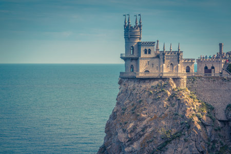 Castle of Swallow's Nest on the rock, Crimea, Russia. Beautiful scenic view of the castle at the precipice. Unusual castle over the Black Sea. The vintage postcard of Crimea castle for background.のeditorial素材