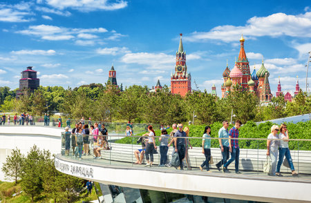 Moscow - June 17, 2018: People visit the Zaryadye Park near Moscow Kremlin, Russia. Zaryadye is one of the main tourist attractions of Moscow. Scenic view of St Basil Cathedral in Moscow centre.のeditorial素材