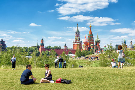 Moscow - June 17, 2018: People relax in Zaryadye Park near Moscow Kremlin, Russia. Zaryadye is one of the main tourist attractions of Moscow. Scenic view of St Basil Cathedral in Moscow centre.のeditorial素材