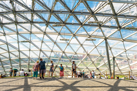 Moscow - June 17, 2018: People visit a modern amphitheater with glass dome in Zaryadye Park near Moscow Kremlin in summer, Russia. Zaryadye is one of the main tourist attractions of Moscow.のeditorial素材