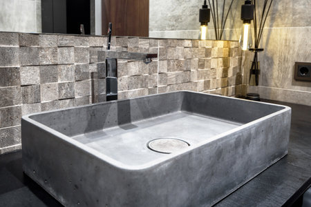 Moscow - March 25, 2018: Modern stylish restroom in a hotel or residential house. Interior design with concrete sink in the bathroom. Contemporary minimalist gray interior.のeditorial素材