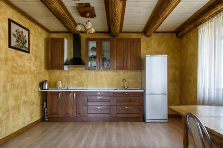 Moscow - May 2, 2018: Interior of kitchen in country house or hotel. Wooden room interior in daylight. Interior design of kitchen in vacation home.のeditorial素材