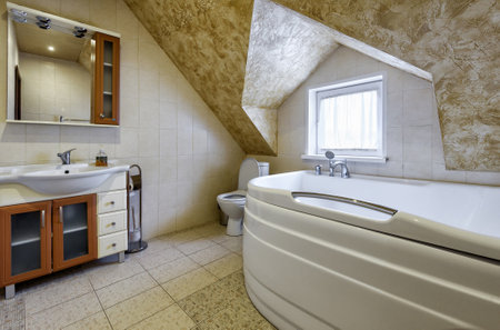 Moscow - May 2, 2018: Interior of bathroom in country house or hotel. Interior design of restroom in vacation home. Modern bathroom in mansard.のeditorial素材