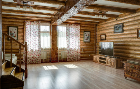 Moscow - May 2, 2018: Interior of country house or hotel in rural style. Interior design of a living room in vacation home. Wooden hall interior in daylight.のeditorial素材