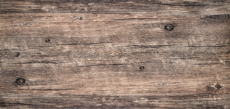 Wood texture background. Top view of dark vintage wooden table with a cracks. Brown rustic rough wood for backdrop. Surface of old knotted wood with nature color, texture and pattern.の写真素材