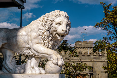 Crimea - May 20, 2016: Marble statue of a lion at the Vorontsov Palace in Crimea, Russia. Classical marble lion sculpture outdoor. Beautiful view of detail of the famous Crimea landmark in summer.のeditorial素材