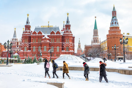 Moscow, Russia - February 5, 2018: People visit the Manezhnaya Square near Moscow Kremlin in winter. It is one of the main tourist attractions in Moscow. Nice view of central Moscow during snowfall.のeditorial素材