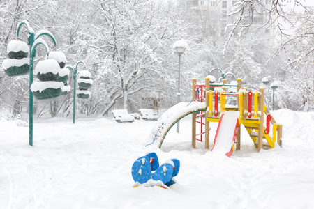 Snowy playground in winter, Moscow, Russia. Empty urban park during snowfall. Scenery of the kindergarten in the winter city.の写真素材