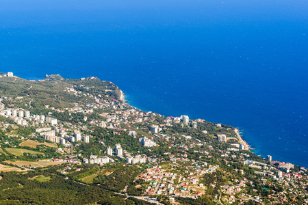 Aerial panoramic view of the seaside city, Crimea, Russia. Landscape of the Black sea coast in South Crimea in summer. Scenic panorama of the Crimea coastline from above.の写真素材
