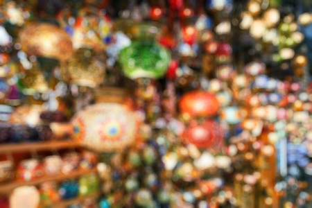Lamps in Grand Bazaar as creative abstract blur background, Istanbul, Turkey. Colorful craft gifts in oriental bazaar. Stained glass lamps in artisan market. Shopping in Middle Eastern bazar.の写真素材