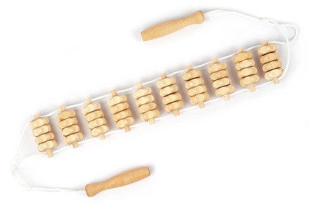 Massage equipment isolated on white background. Wooden massager for back and skin care treatment. Personal roll tool for relax massage.の写真素材